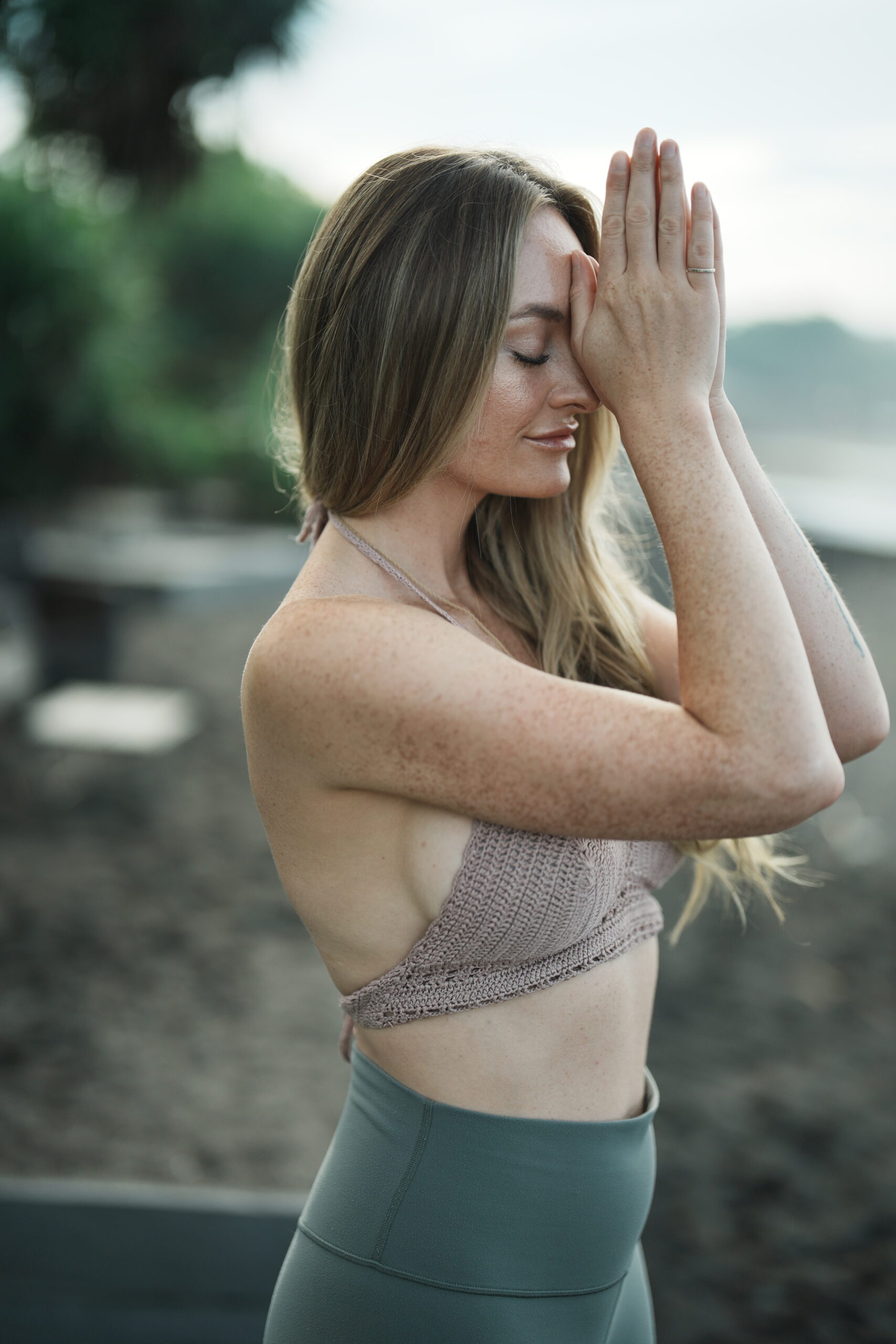 a girl doing yoga on the beach